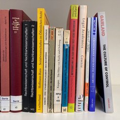 Various books on law and sociology on the shelf.